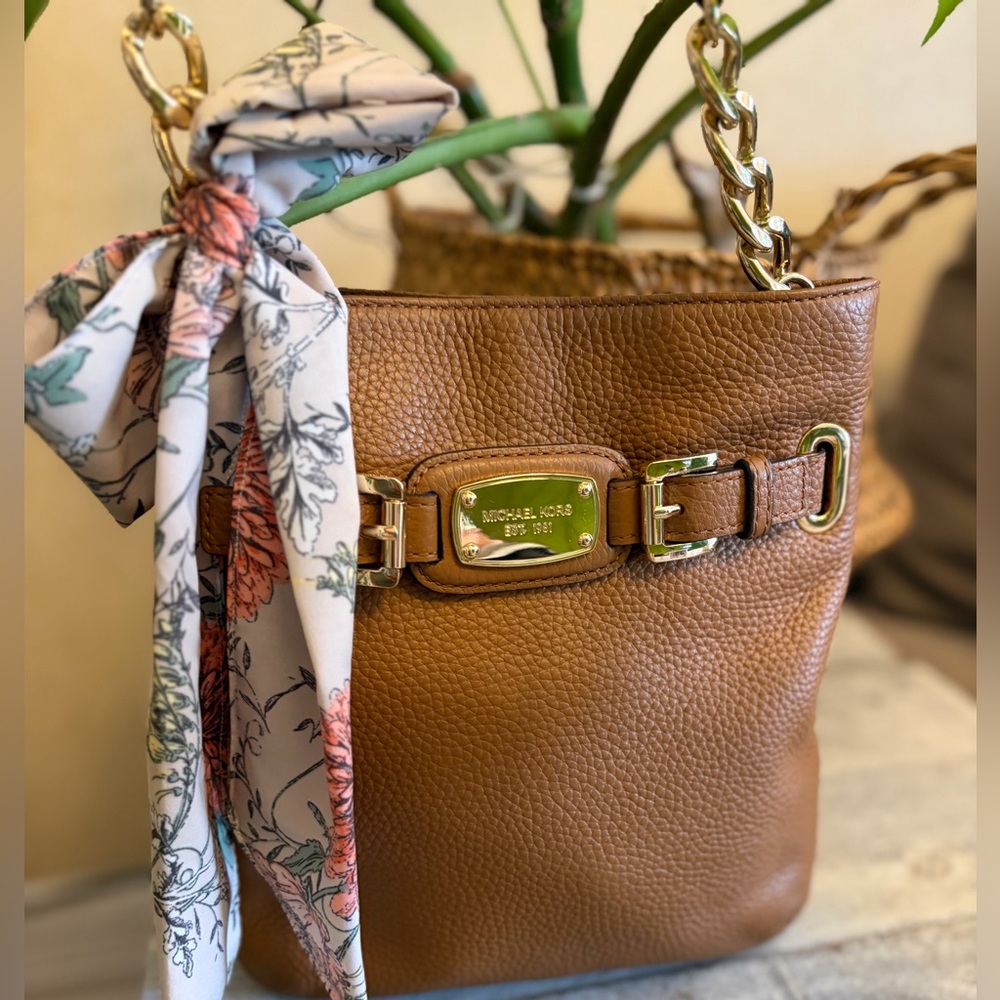 Michael Kors Tan Pebbled Leather crossbody with Gold Chain in the strap.